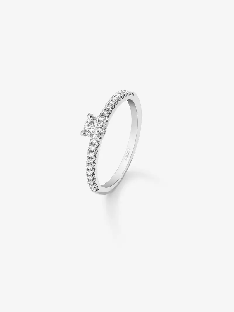 Anillo de oro blanco de 18K con diamante central en talla brillante de 0,12 cts y brazo de 20 diamantes en talla brillante con un total de 0,11 cts