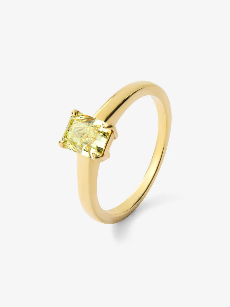 Anillo solitario de oro amarillo de 18K con diamante central Fancy Yellow en talla radiant de 0,70 cts