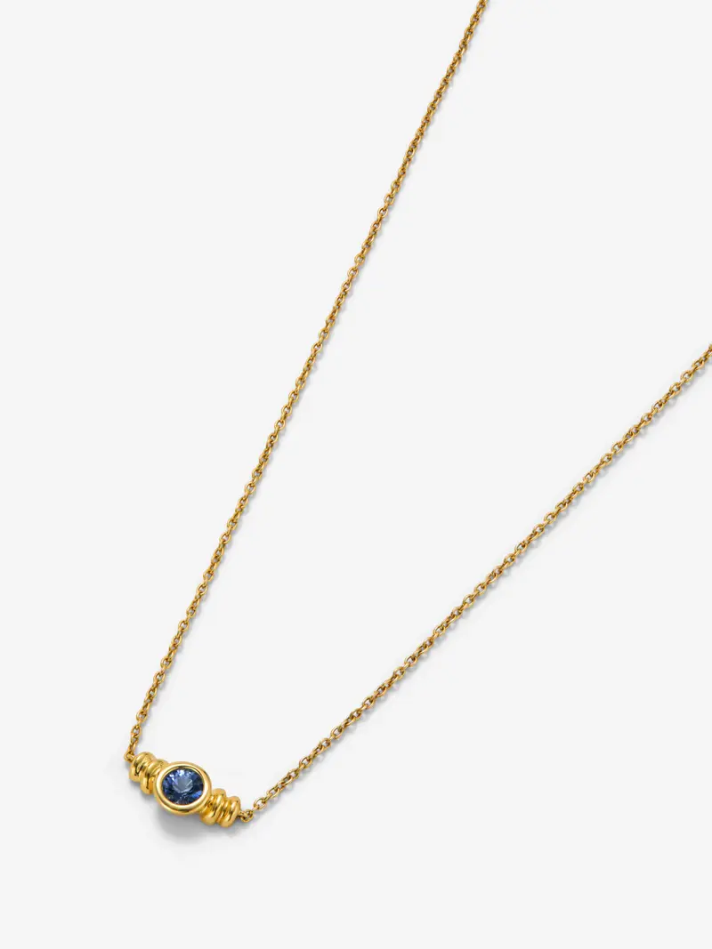 Colgante de oro amarillo de 18K con zafiro azul en talla brillante de 0,15 cts