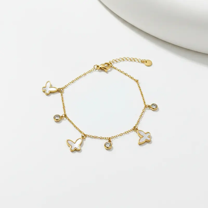 Pulsera de acero con mariposas de nácar y circonitas acabado oro