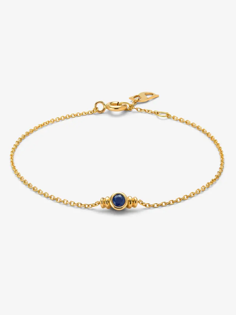 Pulsera de oro amarillo de 18K con zafiro azul en talla brillante de 0,15 cts