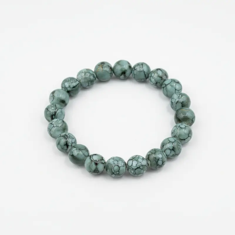 Pulsera elástica con cuentas de color verde y efecto marmolado