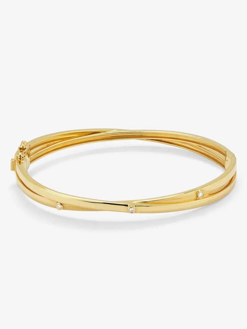 Pulsera rígida cruzada de oro amarillo de 18K con 3 diamantes en talla brillante con un total de 0,04 cts