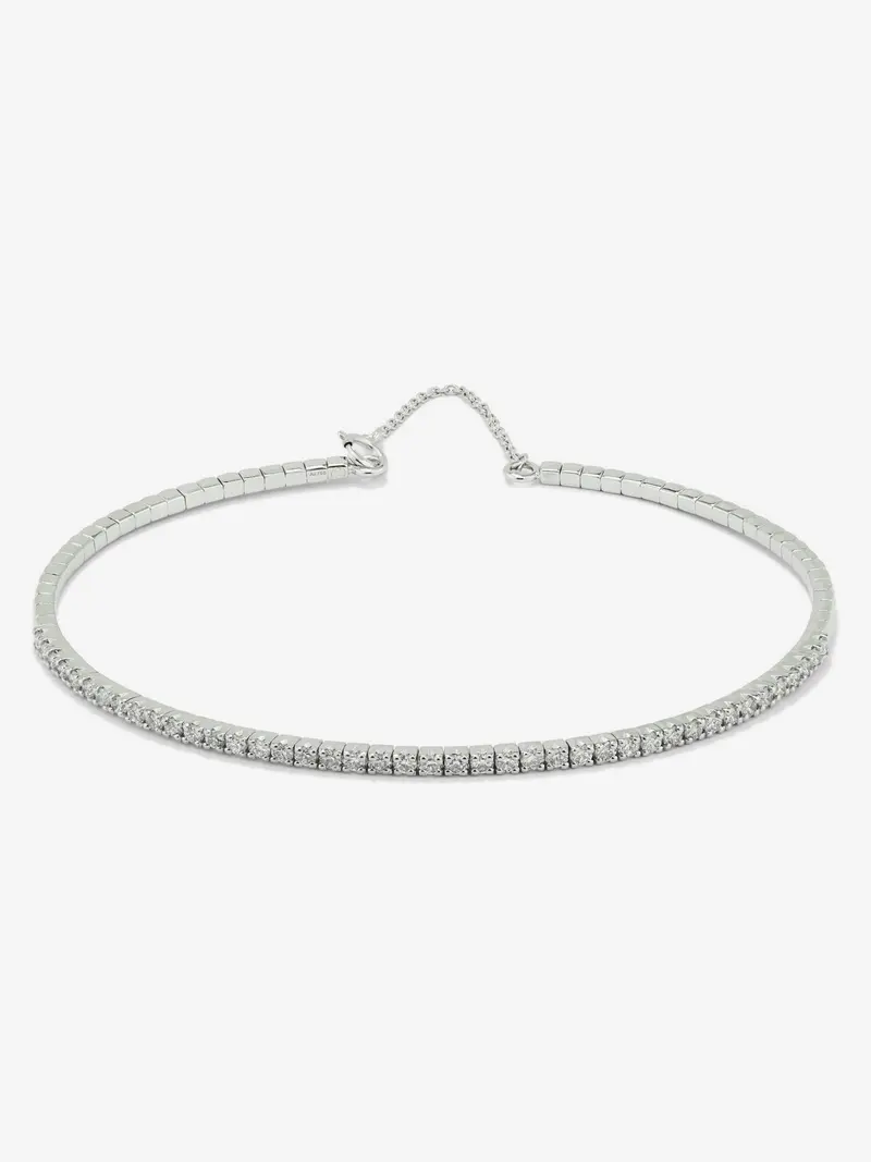 Pulsera rígida de oro blanco de 18K con 42 diamantes en talla brillante con un total de 0,71 cts