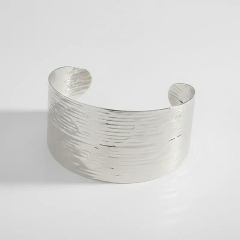 Pulsera tipo brazalete de acero con textura